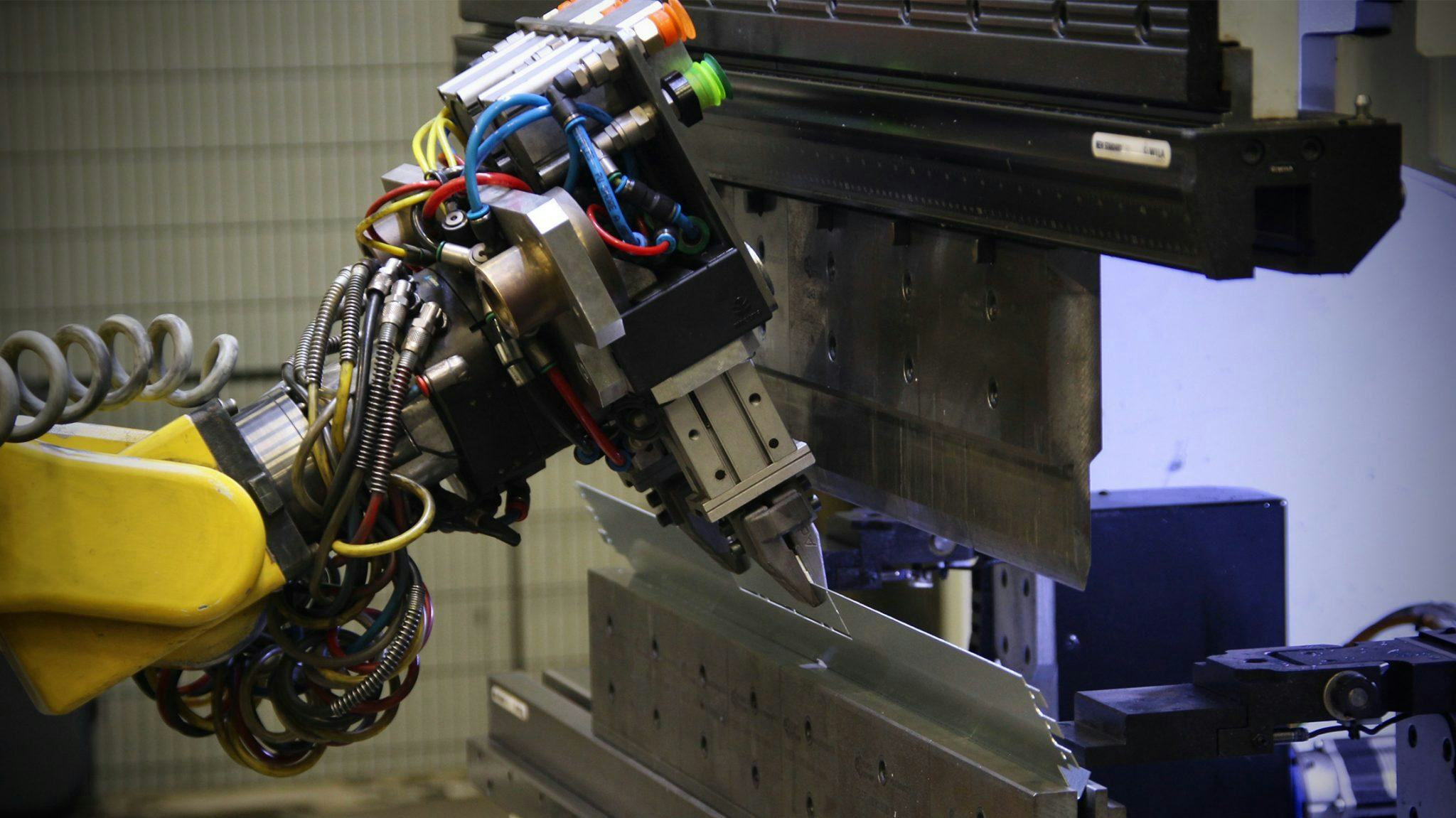 Close-up of robot with the redesigned gripper in action